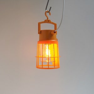 Great industrial work lamp in sunflower yellow plastic and clear glass made by Nordisk Solar Company during the 1970s