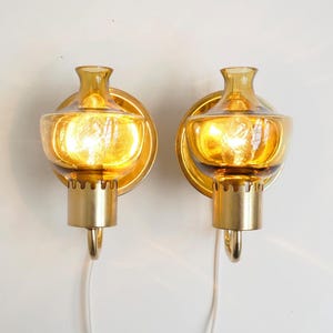 Beautiful pair of brass sconces with colored glass shades from Örsjö Belysning  - Swedish vintage design from the 1960s