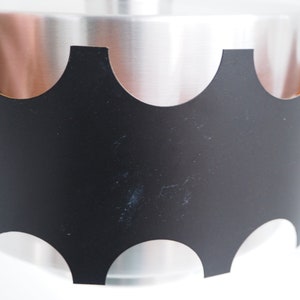 May include: A black metal pendant light fixture with a scalloped edge and a silver interior.