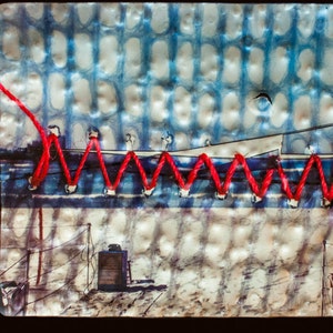 May include: A close-up of a mixed media artwork featuring a blue and white patterned background with a red thread stitched in a zig-zag pattern across the top. The bottom of the artwork shows a faded image of a fence and a small building.