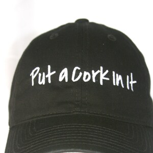 Put a Cork In It - Polo Style Ball Cap (Black with White Stitching)