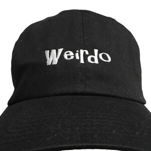May include: A black baseball cap with a white embroidered word "Weirdo" on the front.