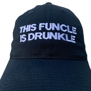 May include: A black baseball cap with white embroidery that reads "This Funcle Is Drunkle".