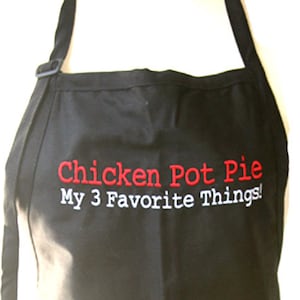May include: Black apron with white and red embroidery that reads "Chicken Pot Pie My 3 Favorite Things!"