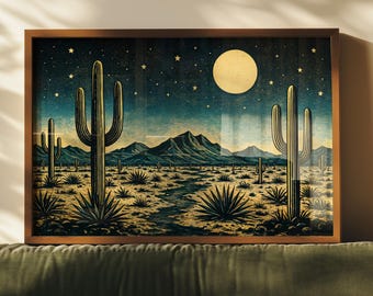 May include: A framed print depicting a desert landscape under a starry night sky. The artwork features tall cacti, a full moon, and mountains in the distance. The color palette includes shades of blue, gold, and brown, creating a serene desert scene.
