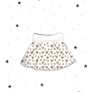 May include: A white skirt with a leopard heart print. The skirt has a white waistband and a flared silhouette. The background is white with scattered blue dots and black star illustrations. The brand name "lil boo" is in the bottom right corner.