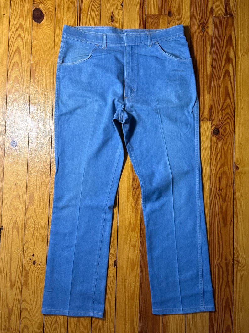 May include: A pair of light blue denim jeans with a straight leg fit.
