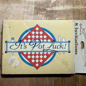 May include: A yellow card with a red and white checkered design inside a blue circle. The text "It's Pot Luck!" is written in black cursive lettering. The card is labeled "8 invitations" and "Hallmark" in the top right corner.