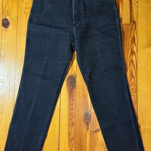 May include: A pair of dark blue denim jeans with a high waist and a straight leg.