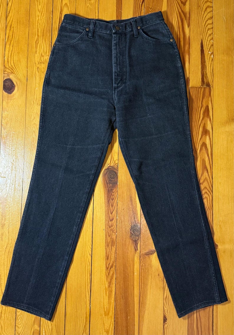 May include: A pair of dark blue denim jeans with a high waist and a straight leg.
