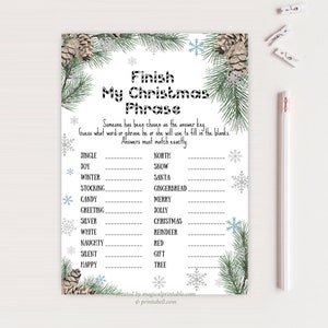 May include: A printable Christmas game card titled "Finish My Christmas Phrase." The white card features a festive design with pine branches, snowflakes, and pinecones. The game includes fill-in-the-blank phrases. A pencil and clips are on the side.