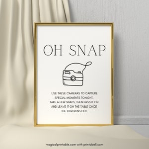 May include: A printable sign with the text "OH SNAP" and a drawing of a camera. The text below the camera reads "Use these cameras to capture special moments tonight. Take a few snaps, then pass it on and leave it on the table once the film runs out."