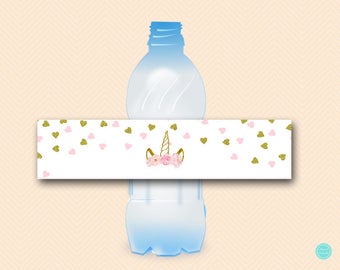 May include: A white water bottle label with a pink and gold unicorn design. The label features a unicorn head with a pink flower crown and gold glitter hearts scattered around it.