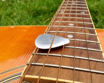 Pure silver // Guitar pick, plectrum // Handmade in UK // Can be engraved and supplied with hole / jump ring for necklace