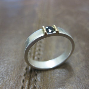 Hand forged fine silver band with 3mm natural sapphire bound in 18k gold. Suitable for engagement, wedding or just a special gift.