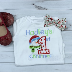 Baby girl&#39;s personalized first Christmas snowman bodysuit