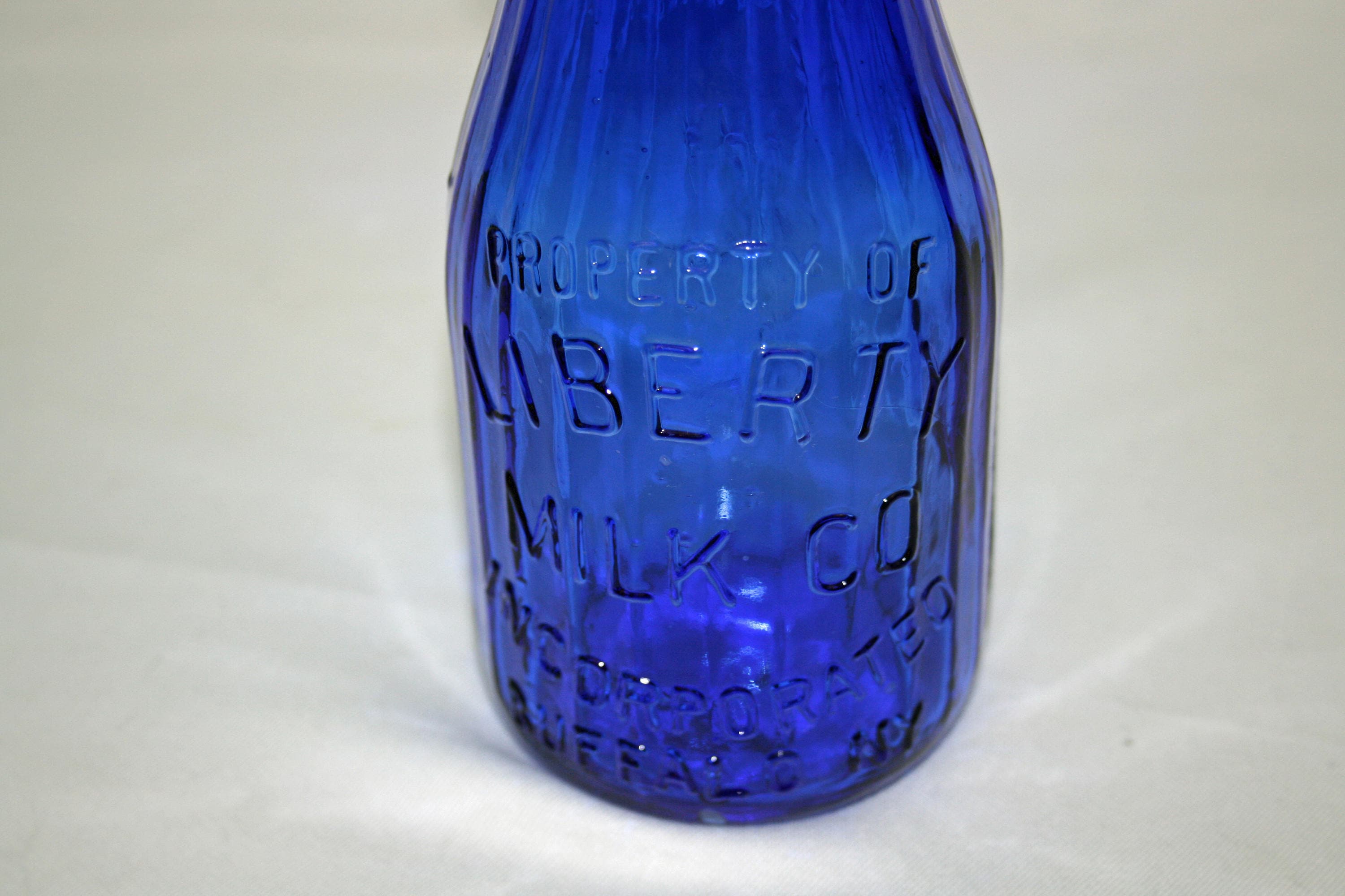 Liberty Milk Co. Buffalo NY Cobalt Blue One Pint Ribbed Bottle Statue