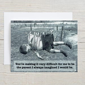 May include: A black and white photograph of a child hanging upside down from a clothesline. The child is wearing a shirt and shorts. The caption reads "You're making it very difficult for me to be the parent I always imagined I would be."