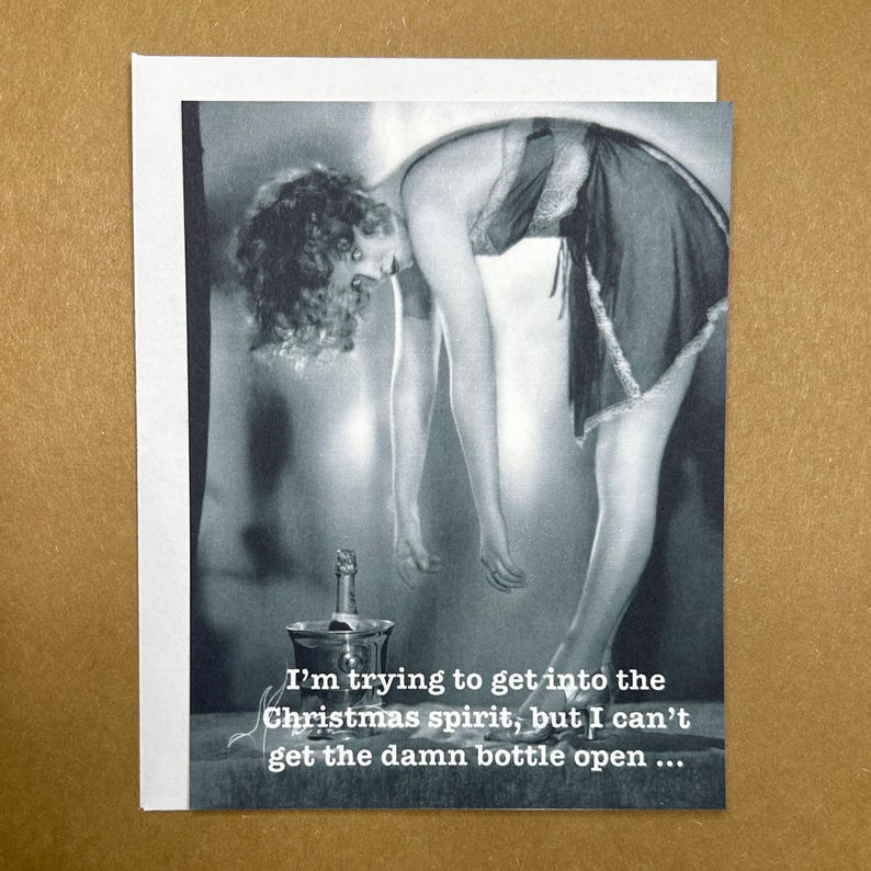 May include: A black and white vintage style photo of a woman in a dress trying to open a bottle of wine. The caption reads "I'm trying to get into the Christmas spirit, but I can't get the damn bottle open..."