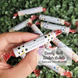 May include: White candy roll sticker labels with red twist ends, featuring black, gold, and white polka dots. Text reads "Congrats Elizabeth CLASS OF 2025." The labels are for graduation.