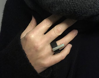 Black leather ring with RAK-1/2 bar