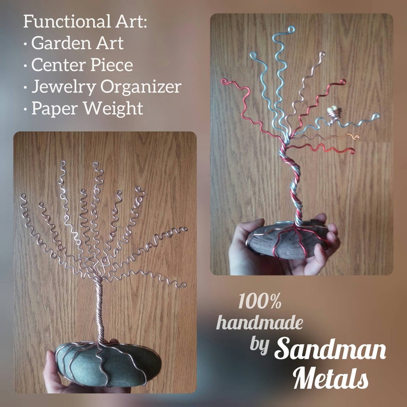 May include: Two handmade wire trees with a twisted wire trunk and curled wire branches. The trees are on a stone base. The text "100% handmade by Sandman Metals" is at the bottom of the image.