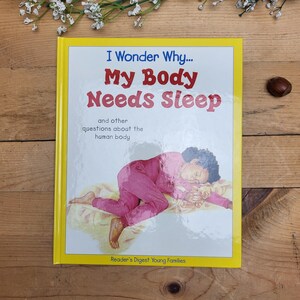 May include: A children's book titled "I Wonder Why... My Body Needs Sleep" with a yellow border. The cover shows a child in pink pyjamas sleeping. The book is from Reader's Digest Young Families.