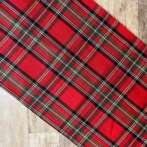 Red tartan linen table runner with classic plaid pattern.