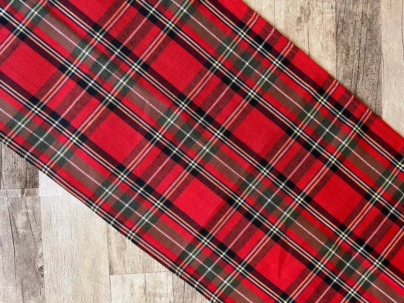 Red tartan linen table runner with classic plaid pattern.