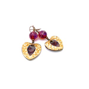 Earrings made with a heart-shaped charm featuring 2 angel wings in shades of cream with maroon in the center hang below matching maroon handmade lampwork glass beads.  Hand wrapped with copper wire.  Copper ear wires.