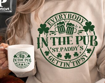 May include: A light beige sweatshirt with a green circle design that says "Everybody in the Pub *St. Paddy's* Gettin' Tipsy". The design features shamrocks and a pair of beer mugs.