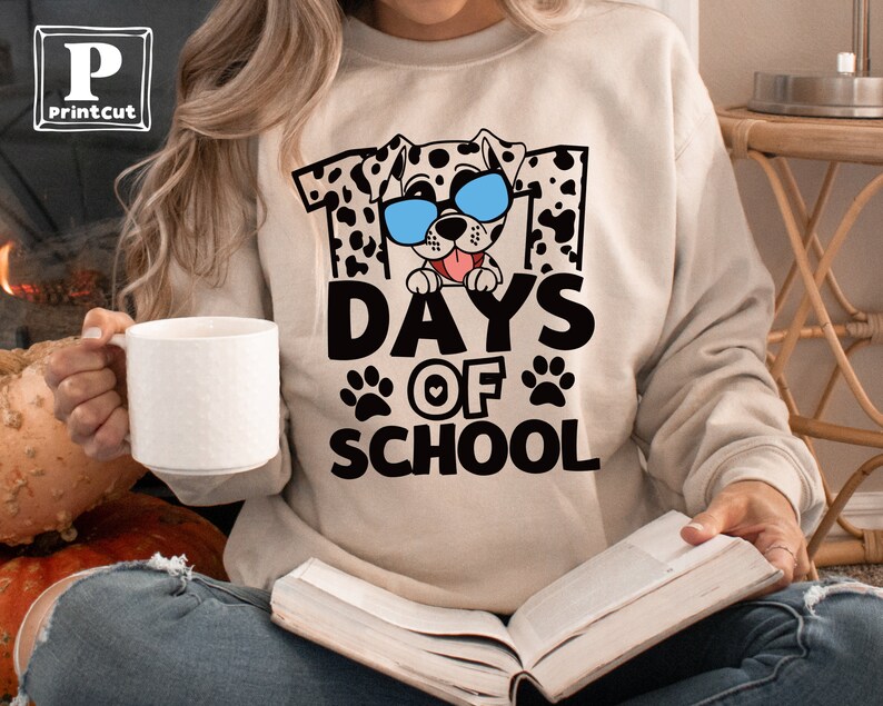 K&ouml;nnte beinhalten: Ein beiger Pullover mit einem Aufdruck eines Dalmatiners mit Sonnenbrille und dem Text "101 Days of School".