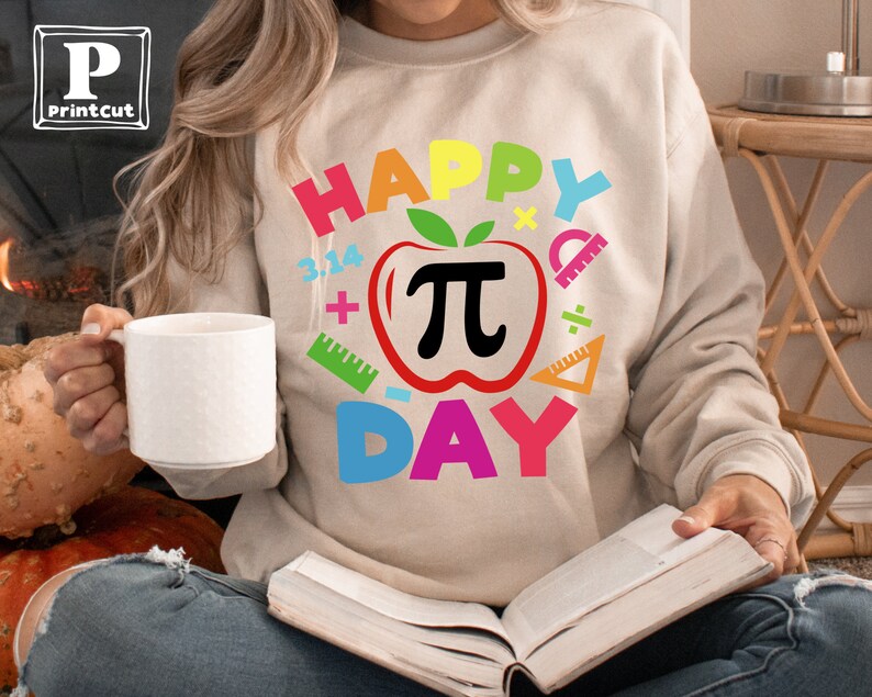 May include: A beige sweatshirt with the text "Happy Pi Day" in rainbow colors. The design includes a red apple with a black pi symbol and various math symbols.
