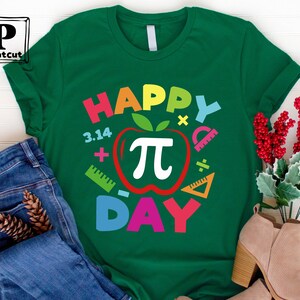 May include: Green t-shirt with the text "Happy Pi Day" in rainbow colors. The text is surrounded by a red apple with a white pi symbol and other math symbols.