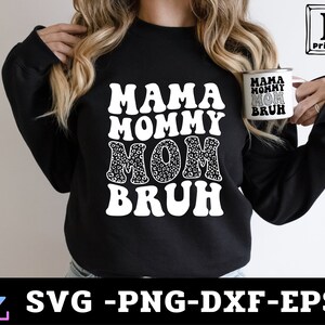 May include: Black sweatshirt with white text that reads "Mama Mommy Mom Bruh" in a retro font. The text is surrounded by a leopard print pattern.