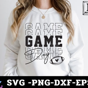 May include: White sweatshirt with black text that reads "GAME DAY" with a stylized football graphic.