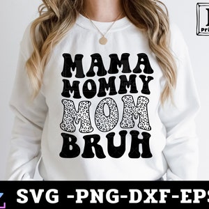 May include: White sweatshirt with black text that reads "Mama Mommy Mom Bruh" with a leopard print design in the word "Mom".