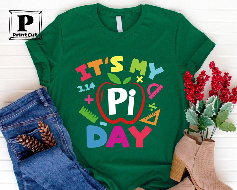May include: Green t-shirt with the text "It's My Pi Day" in rainbow colors. The text is surrounded by a red apple with a white "Pi" inside and math symbols.