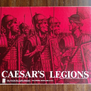 May include: A red box cover for the board game "Caesar's Legions" by The Avalon Hill Game Company. The cover features a black and white illustration of Roman soldiers in formation.