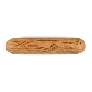 May include: A wooden rolling pin with a carved design. The rolling pin is light brown in color and has a smooth, rounded surface.