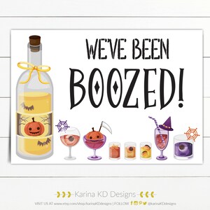 Könnte beinhalten: Ein weißes Schild mit dem Text "We've Been Boozed!" in Schwarz. Das Schild zeigt eine Cartoon-Illustration einer Flasche Schnaps mit einem Kürbis darin, einem Spinnennetz und sechs verschiedenen Halloween-Cocktails.