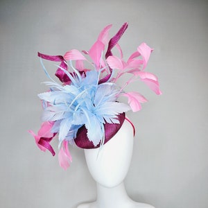 kentucky derby hat fascinator dark fuchsia purple sinamay with large light blue feather flower and light pink feathers with sinamay curls