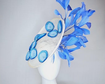 kentucky derby hat fascinator white sinamay saucer with light blue sky blue cobalt blue organza silk flowers, cobalt blue branching feathers