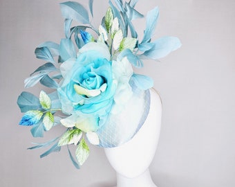 kentucky derby hat fascinator light blue satin with netting, sky blue organza rose flower,blue and green leaves,teal blue branching feathers