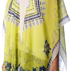 May include: A yellow, open-front kimono-style cover-up with a white border. The cover-up features a repeating pattern of navy blue floral and geometric designs. The fabric appears lightweight and semi-sheer.