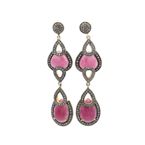 May include: A pair of long, dangling earrings with pink gemstone drops surrounded by a silver and gold filigree design.