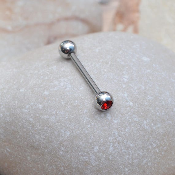 Third nipple piercing with purple barbell