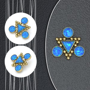 May include: A set of three blue opal earrings with gold accents. The earrings are in the shape of a triangle with a smaller triangle in the center. The earrings are set on a white background.