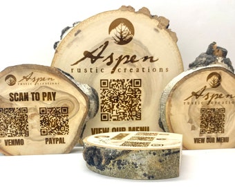 May include: Four wooden slices with the text "Aspen rustic creations" and a QR code. The top slice has the text "VIEW OUR MENU". The bottom slice has the text "SCAN TO PAY" with two QR codes labeled "VENMO" and "PAYPAL".