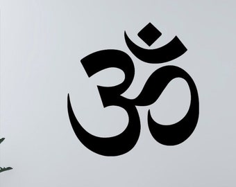 May include: A white living room with a white couch, two white chairs, and a white ottoman. A large black Om symbol is on the wall. A potted plant is in the corner of the room.